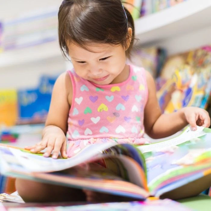Little girl reading a book